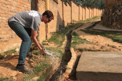 Auburn-University-Water-Kabaya-Rwanda-Aug.-2017-_Stephen-Gass-chemical-engineering-student-adjusting-the-pipeline-to-the-school-as-it-receives-water-for-the-first-time