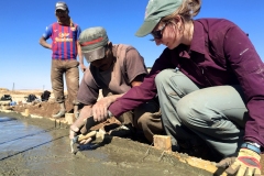 Columbia-University-Water-Ilguiloda-Morocco-Aug.-2015-community-member-Mohammed-teaches-EWB-USA-Columbia-University-member-Madison-how-to-smooth-concrete